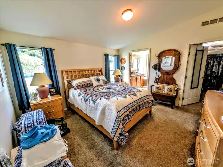 Primary bedroom with bath and walk-in closet.