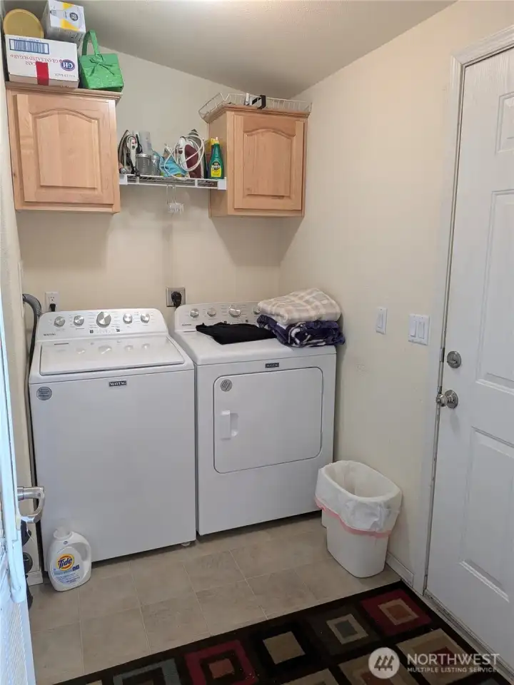 Utility room - door to the right leads to breezeway and garage. Washer and dryer are approx one year old.