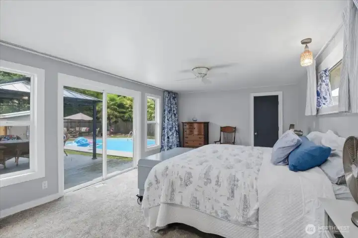 Primary bedroom with slider to deck & pool