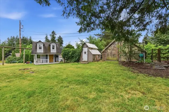 Front yard showing playhouse, chicken coop and greenhouse