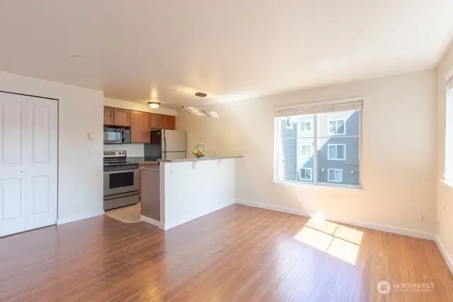 Love this new flooring and great natural light throughout!  Door to the left of kitchen houses the washer/dryer and the newer hot water heater