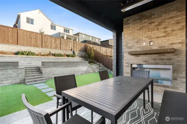 Covered patio with custom lighting, space heaters and fireplace. Enjoy this space year round.