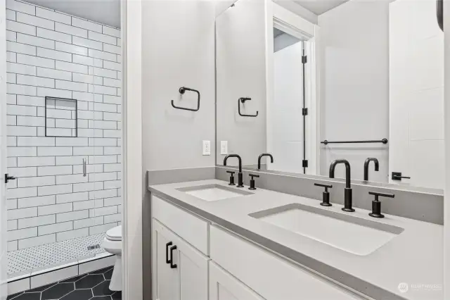 Lower level bathroom. Oversized custom tiled shower, dual sinks and quartz countertops.