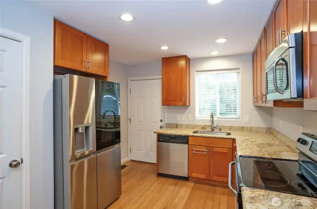 The kitchen sink offers a picturesque view of the backyard and deck, perfect for enjoying the sights of local wildlife.
