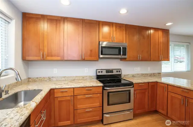 Stunning cabinets complement the kitchen, beautifully paired with granite countertops.
