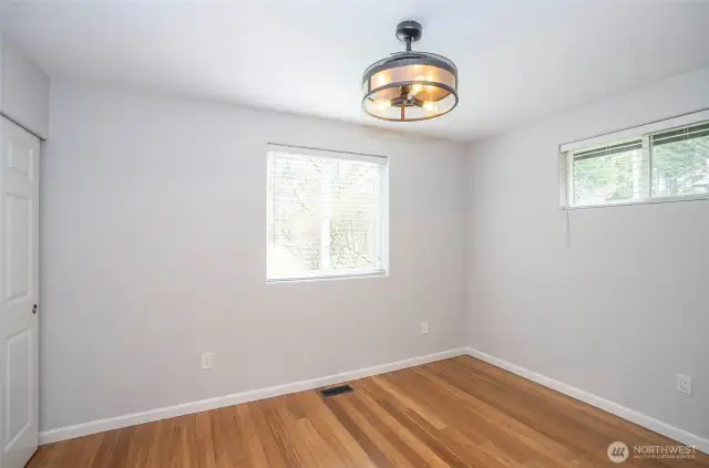 The primary suite showcases stunning flooring and abundant natural light.