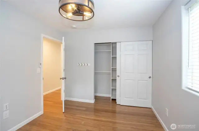 The primary suite offers ample closet space with built-in shelving for optimal organization.