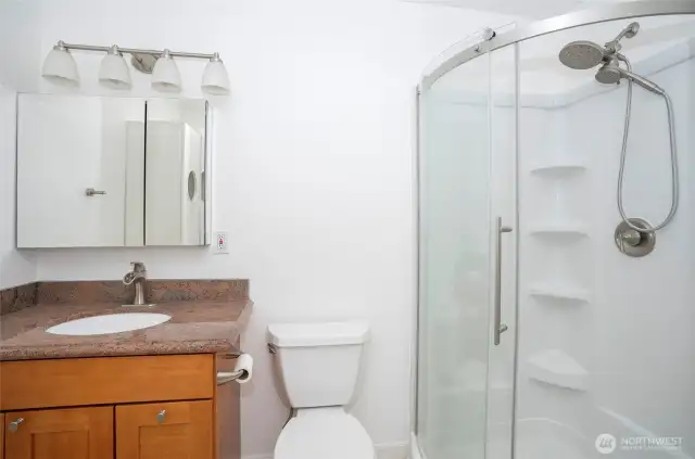 The primary bath boasts a spacious walk-in shower, offering both style and convenience.