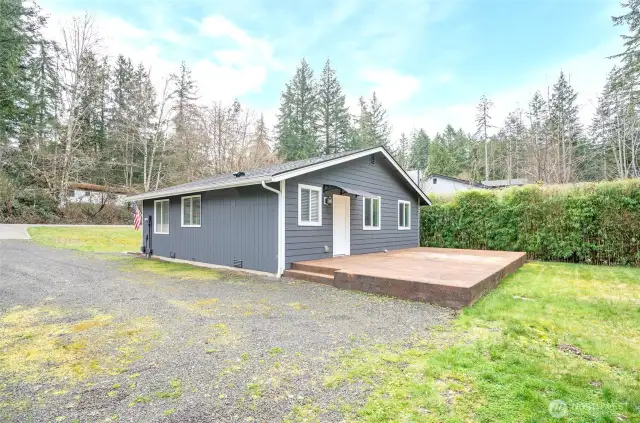 The back of the home boasts a spacious concrete patio, ideal for entertaining and outdoor enjoyment.
