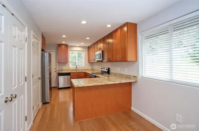 Another perspective of the kitchen and dining area, beautifully illuminated by a large window.