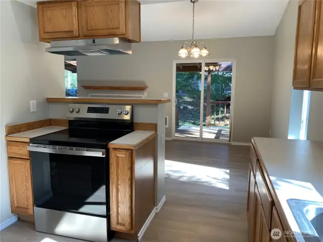 KITCHEN LOOKING TOWARDS DINING AREA, BACK DECK ACCESS