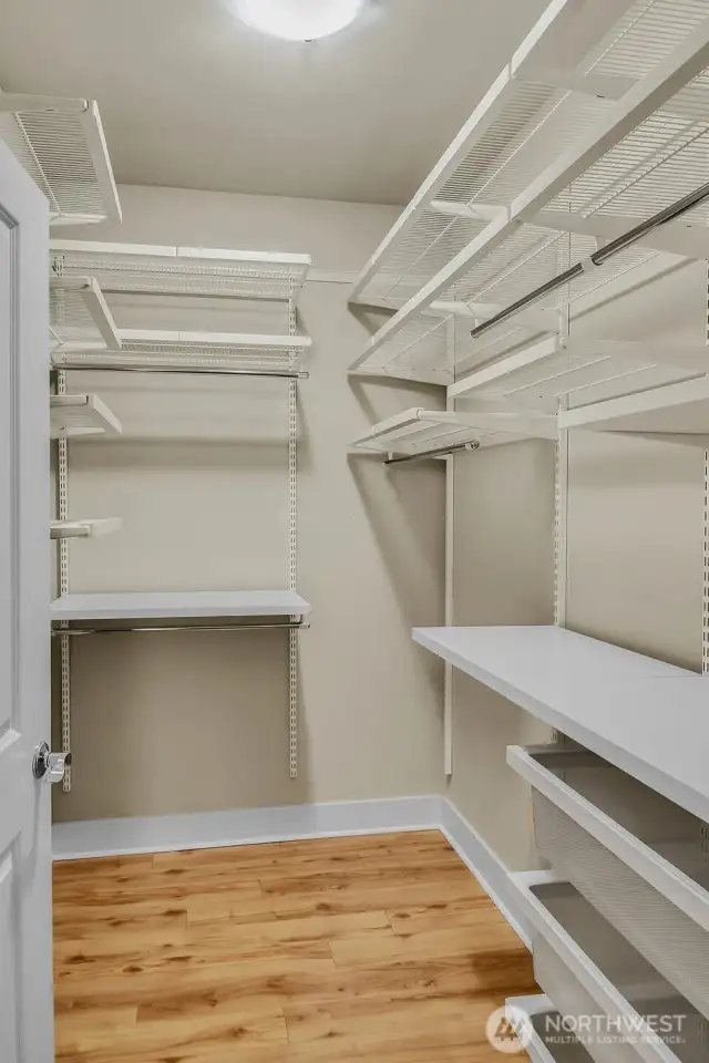 Keep organized with a custom walk-in closet offering shelving, hanging space & drawers.