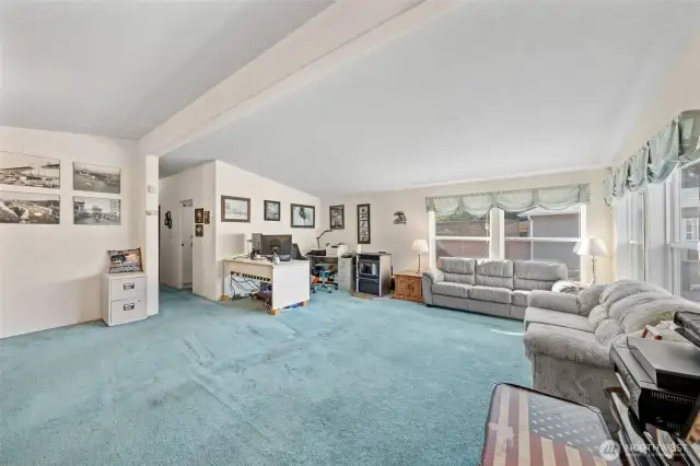 Open expansive living room with ample room for a corner office for easy work at home access.