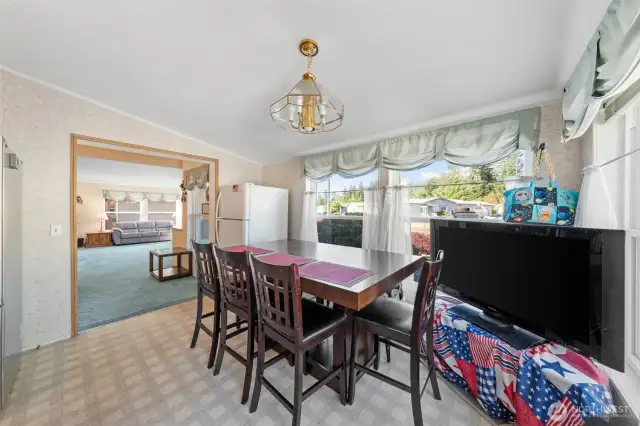 Second eating space in the kitchen or create your own oasis with ample window space perfect for your plant family. The white refrigerator does not convey.