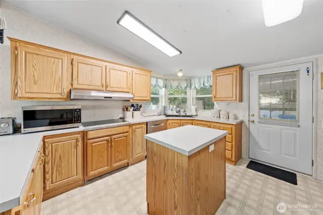 Range, corner sink allowing you to enjoy the outdoor beauty and easy step out access to a covered patio. Perfect spot to stay dry and listen to the pitter patter of the rain.