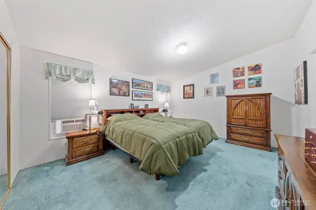 Primary bedroom suite with attached five piece bathroom and enormous walk in closet.