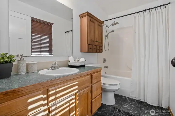 Primary bathroom with tub & shower combo.