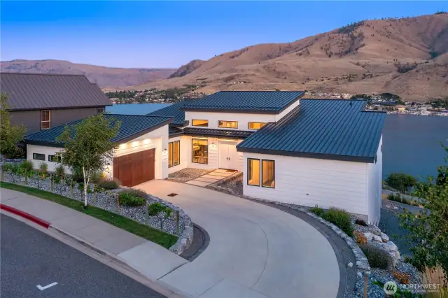 Custom design and build, not a Lookout standard plan. Long driveway with custom edge lighting provides additional off street parking leading to a full size 2 car garage.