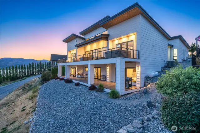 From the back the house shows it's true size. Truly designed to maximize the view at every turn. And decks run the length of the home both upper and lower.