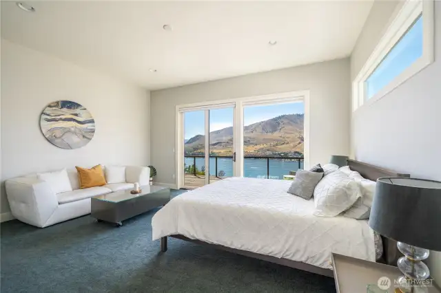Main floor primary bedroom and en suite are spacious and filled with views, too! Prewired to add a chandelier or a ceiling fan if you so desire.