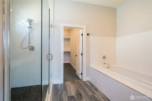 Taller people will love the extra long tub and high shower head. Natural rock floor and in-line drain system make this shower feel like a spa!