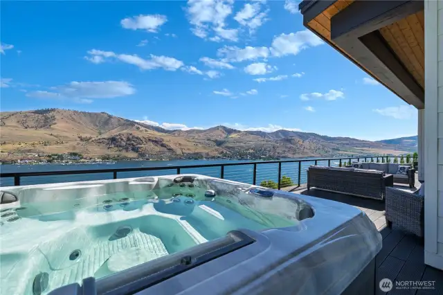 Daytime view of the 7 person hot tub which can be accessed from both the living room and the primary bedroom.