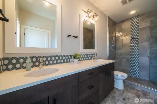 Ensuite bathroom feels like a primary! Double sinks and large shower, beautiful floor to ceiling tiles and loads of storage.