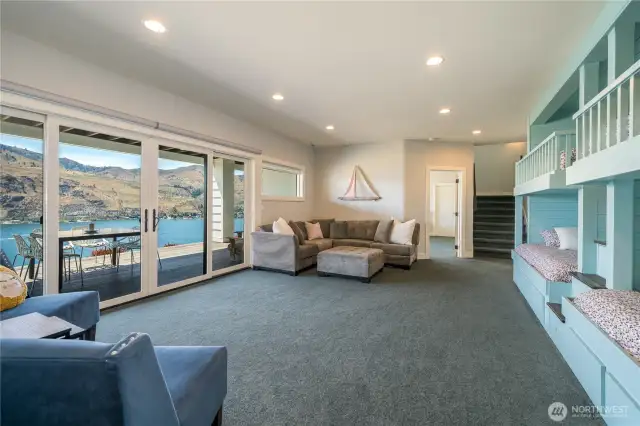 This is the bunk room/game room downstairs! Big enough for a crowd, deck access here too!