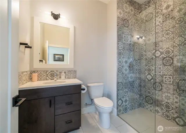 Gorgeous 3/4 bath next to the guest room on the main level. This level entry shower with no lip and inline drain makes this space so accessible. That brings the total to 4 bedrooms, four bathrooms (2 of them en suite) plus the bunkroom! Lots of space to enjoy!