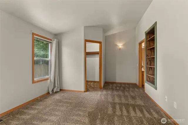 Spacious primary suite with vaulted ceiling, walk-in closet and 3/4 bath.