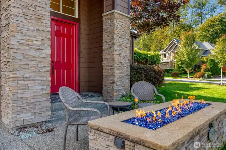 A fire pit setting the ambiance at the front door. great for congregating with neihors