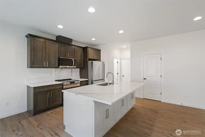 Kitchen with stainless appliances, built-in microwave, dishwasher, range/oven, refrigerator