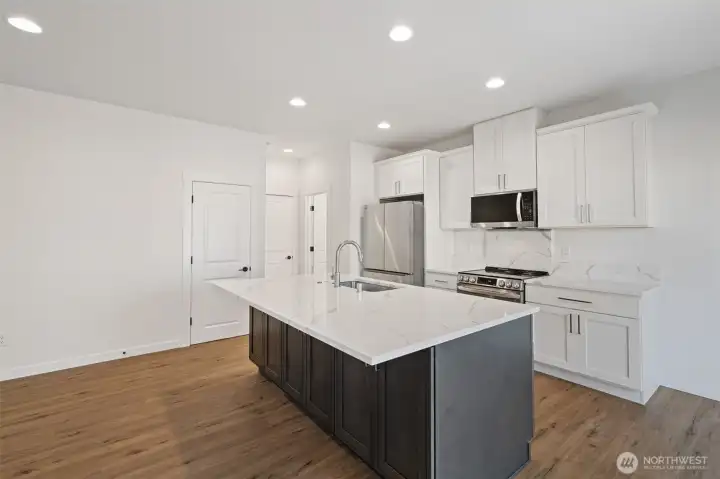 Kitchen with stainless appliances, built-in microwave, refrigerator, range/oven, dishwasher