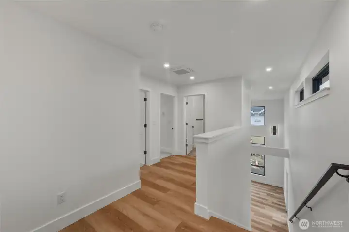 The upstairs landing area showing the 2 bedrooms and shared full bath.