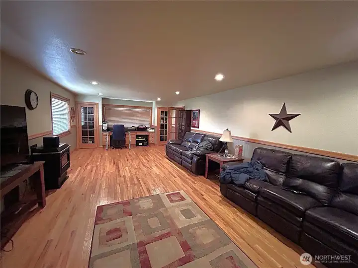 Living and entertaiment room that was added in 1985. Has gas stove and hardwood floors , french doors and office area