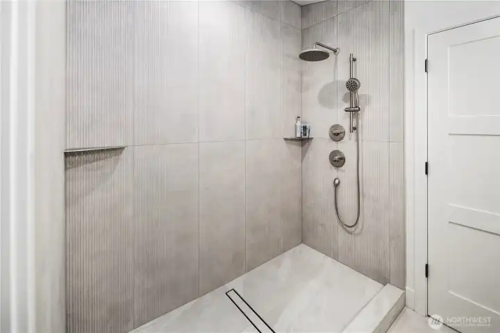 Huge walk in shower with strip drain.  3/4 shower glass panel will be included