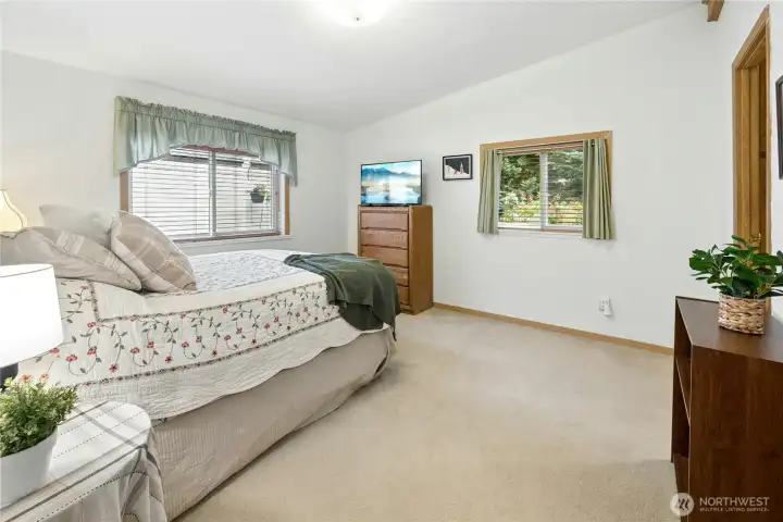 Large ensuite bedroom is at the back of the home, with window overlooking your private garden