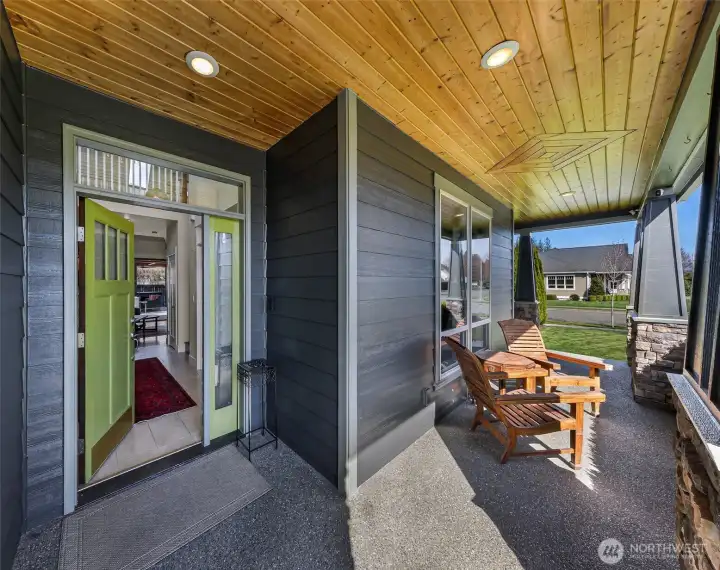 Covered front entry with cedar lined roof and inset lighting creates a comfortable space to enjoy the neighborhood views!
