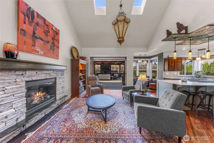 Cozy main living area flows seamlessly into kitchen and breakfast nook. You will be delighted by the 18 foot vaulted ceilings, cozy gas fireplace and the custom light fixtures
