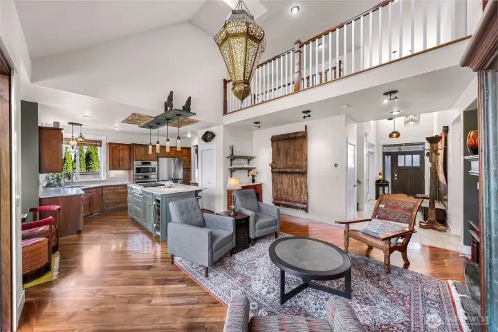 Looking from your outdoor space into your homes main living area with walnut floors throughout and custom remodeled kitchen, you will notice no detail has been left out.