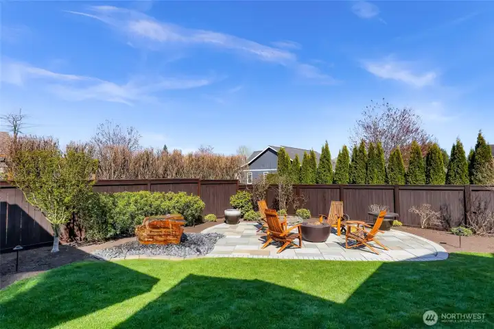 The backyard oasis continues with a second propane fire pit, professionally plumbed with a 100 gallon tank.