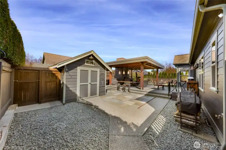 Opposite side of back yard, continues with being fully fenced and recently stained, large shed has plenty of storage and all the electrical for your incredible outdoor living space.