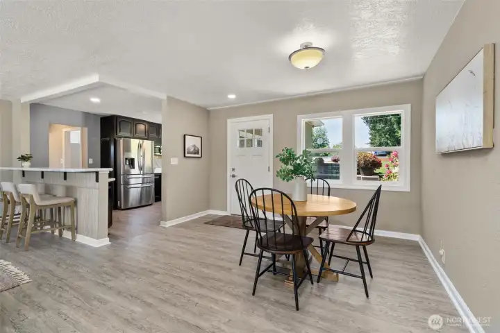 Main dining leading into great room with breakfast bar
