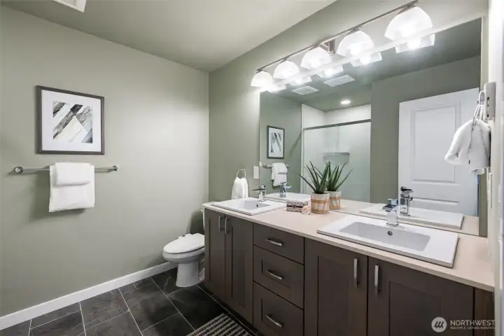 Refreshed bathroom with dual sinks at the vanity and newer tiled shower. Refreshed bathroom with dual sinks at the vanity and newer tiled shower.