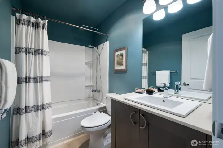 The full-size guest bathroom with a deep, soaking tub and good vanity storage. The full-size guest bathroom with a deep, soaking tub and good vanity storage.
