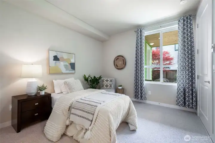 The lower level bedroom has high ceilings and the windows go out to the covered patio and garden. It has its own ensuite full bath. The lower level bedroom has high ceilings and the windows go out to the covered patio and garden. It has its own ensuite full bath.
