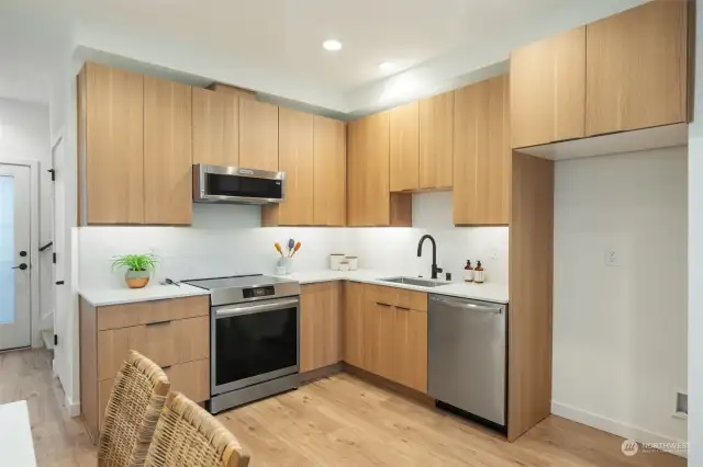 Kitchen features Quartz Countertopes, Full Height Tile Backsplash, Stainless Appliances, Under cabinet Lighting!   Photos are of a completely different floorplan and are representative of quality and finishes.  Color schemes vary by location.