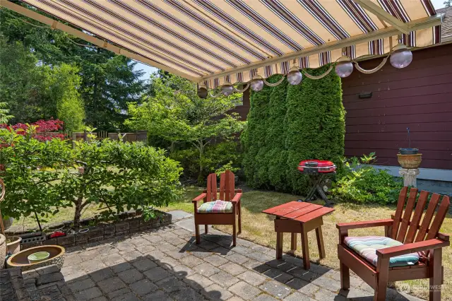 Sunny patio off dining room with retractable awning.