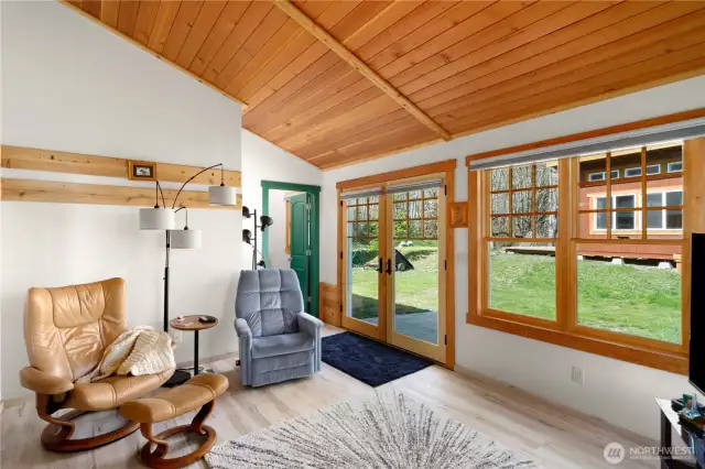 The den with a full bath/laundry room behind the green door. Solar-powered Garden room is outside on the right.