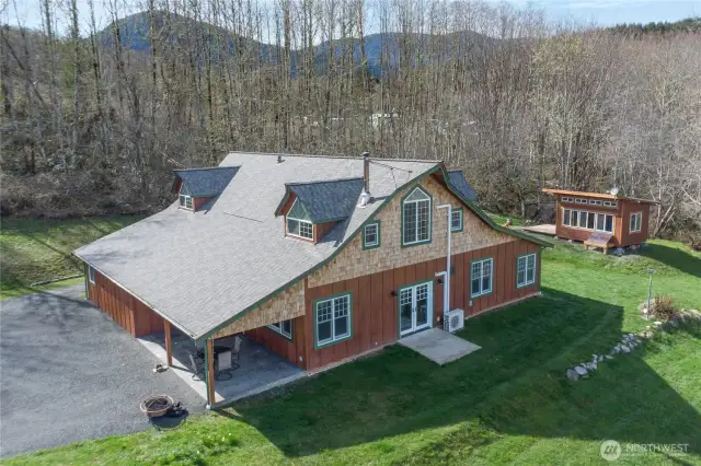 A new 40-year GAF Timberline Roof was installed Fall of 2024. Covered porch on left, Solar Garden shed on right.